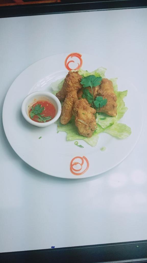 10. Chicken Wings · Served with your choice of sweet-chili or sriracha sauce.