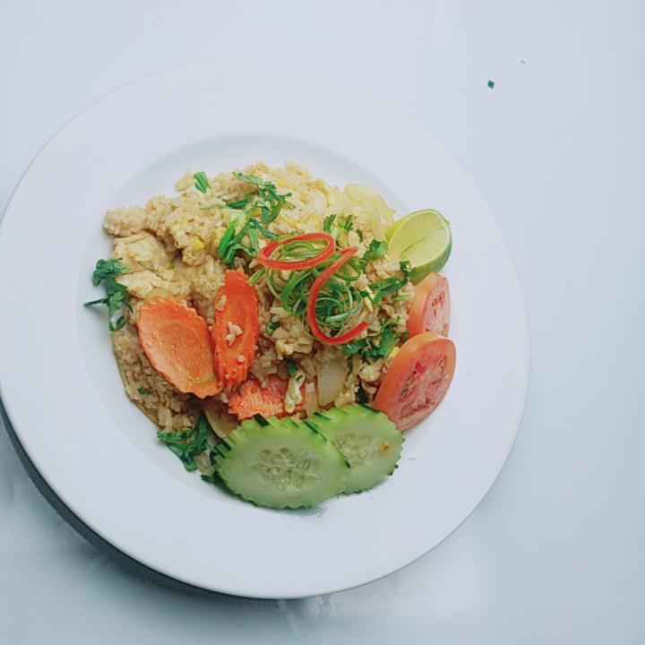13. Thai Style Fried Rice · Tomato, egg, green and white onions, cilantro, and Thai seasoning.