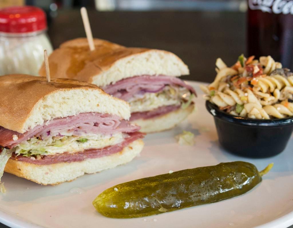 The Highland Sandwich · Italian grinder. Smoked ham, salami, pepperoni, provolone cheese, lettuce, tomatoes, red onions, mayo, Dijon mustard and vinaigrette dressing. Toasted on a choice of baguette with a dill pickle and a choice of side.