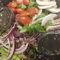 Baby Green Salad · Baby greens, red onions, cherry tomatoes, black olives, mushrooms, coratina extra virgin oli...