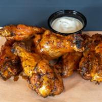 Smoked Wings · Smoked chicken wings tossed in house made spicy wing  sauce served with a side of ranch dipp...