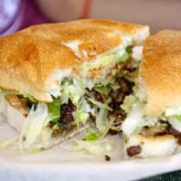 Steak Torta · Served with Beans, Cheese, Lettuce, Tomato and Sour Cream