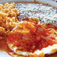 Huevos Rancheros · Sunny Side Up Eggs Covered with Ranchero Sauce and a side of Rice and Beans