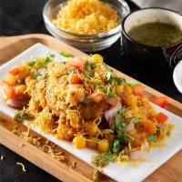 Samosa Ragda Chat · Classic Indian street fare! Samosas topped with onions, garbanzo beans, raita, chutneys and ...