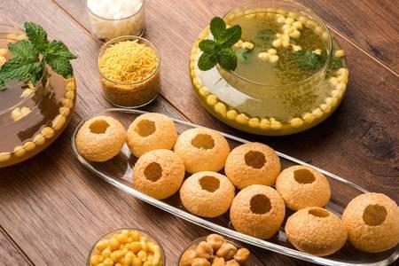 Pani Puri	 · Tiny round hallow crispy puri, filled with delicious stuffing then dipped in flavored juice.