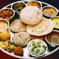 Grand Thali Combo · Special thali served with 2 rotis, white rice, special rice, 7 entrees, curd rice, papad, sa...