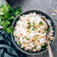 Coconut Rice · Flavorful rice dish with grated coconut and tempered with spices.