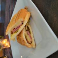 Cuban Sandwich · Slow roasted pork, salt-cured ham, Swiss cheese, Dijon mustard, house-made pickles, French r...
