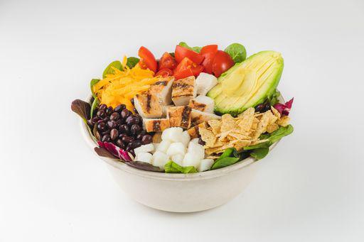 Chicken Chipotle Salad · Organic mixed greens, free-range chicken, roasted corn, jicama, black beans, tomatoes, avocado, cheddar cheese and tortilla chips with creamy chipotle dressing served on the side. Served with sourdough bread. Gluten-free. Spicy.