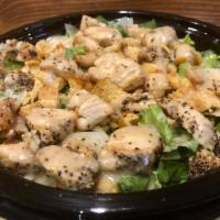 Chicken Caesar Salad · Chopped romaine lettuce topped with grilled chicken, bagel croutons, Parmesan cheese, Caesar...