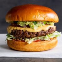 Tex-Mex · Grilled Impossible™ patty with spicy queso sauce, lettuce, guacamole, tomato, and ketchup on...