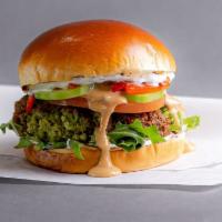 Falafel Burger  · Green chickpea falafel, roasted peppers, tzatziki and tahini hot sauce, arugula, cucumber an...