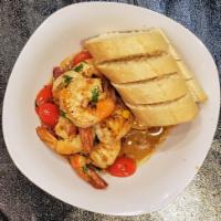 SHRIMP SCAMPI · Garlic, cherry tomatoes, white wine, lemon, parsley topped with a baguette