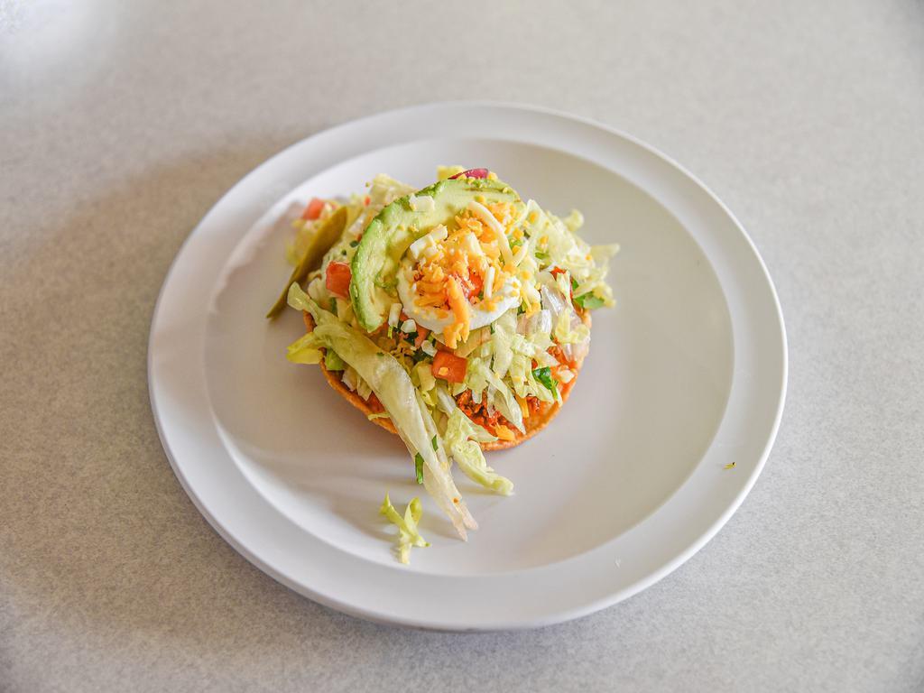 Tostada · Fried tortilla topped with refried beans, lettuce, pico de gallo, avocado, cheese, sour cream and your choice of protein. Lettuce, pico de gallo, cheese, sour cream, and avocado.