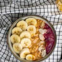Peanut Butter Acai Bowl · Amazonian Acai sorbet served with sliced bananas, topped with almonds and granola clusters, ...