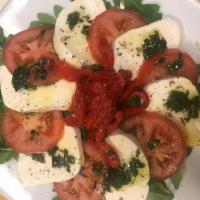 Mozzarella Caprese · Vine tomatoes topped with basil, fresh mozzarella and roasted peppers.