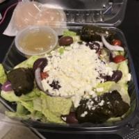 Greek Salad · Romaine lettuce, cucumbers, tomatoes, red onion, feta stuffed grape leaves, calamata olives.