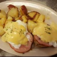 Eggs Benedict · Poached eggs with Canadian bacon on an English muffin, topped with Hollandaise sauce.