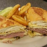 Cuban Sandwich · Roast pork, ham, Swiss cheese, pickles and mustard on a grilled roll. Served with choice of ...