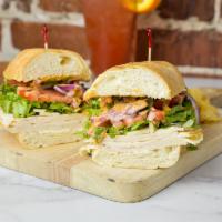 The Clucker Grinder  · Chicken, Swiss, lettuce, tomatoes, onions and micro greens drizzled with our signature Carib...