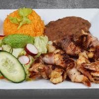 CAMARON COSTA AZUL · Grilled shrimp rolled with cooked bacon, served with rice, beans, green salad and handmade c...