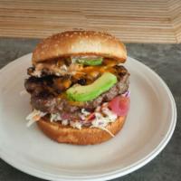 The Burger · Angus beef patty, spread, smashed avocado, grilled mushrooms, coleslaw, cheddar cheese and p...