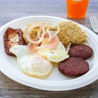 Tres Golpes (Mashed Green Plantains, Salami, Cheese, Eggs) · Mangu, fried salami, fried cheese and fried eggs.
