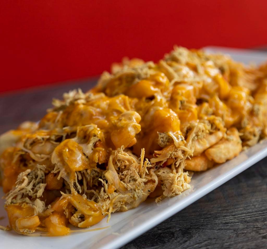 Chicken Supreme Fries · French fries loaded with delicious melted cheese over shredded chicken topped with our delicious sauce.