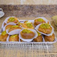 Ashta Eclair · Quarter sheet individual eclairs with container of syrup to pour on top.