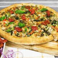 Pesto Veggie Pizza · Homemade garlic pesto sauce and loaded with sun-dried tomatoes, tender red and green peppers...