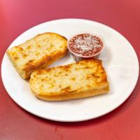 Mamma’s Incredible Cheese Bread · Slices with cup of marinara sauce.