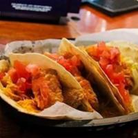 FISH tacos · 6 0z of fried tilapia served on 3 flour tortilla topped with dabomb sauce lettuce tomato and...
