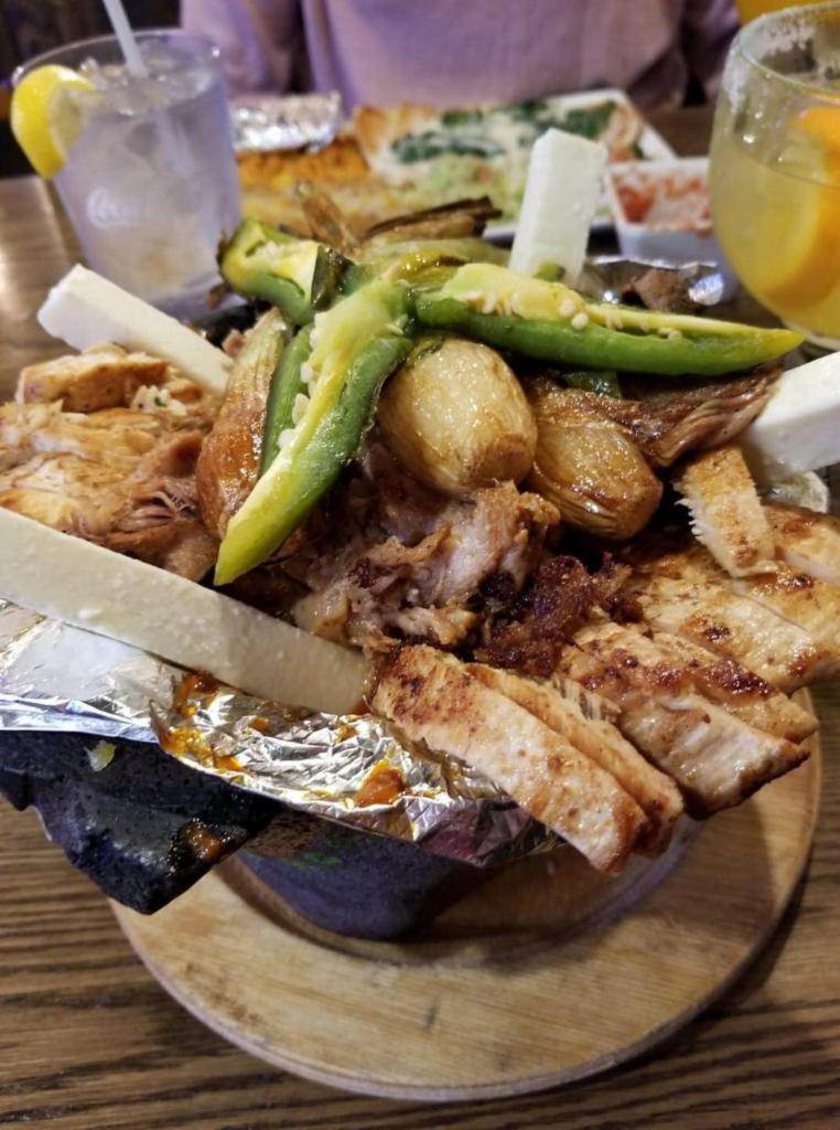 Molcajete carnes · Grilled chicken, steak, shrimp, Mexican sausage, onions, bell peppers, with special sauces, served with rice, bean, lettuce, pico de gallo and guacamole.