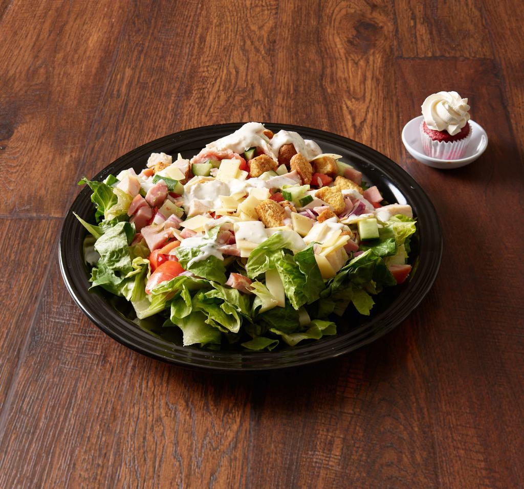 Chef Salad · Crisp romaine lettuce, Swiss cheese, sliced ham and turkey, Roma tomatoes, red onion, and cucumber, and house croutons served with homemade buttermilk ranch dressing.