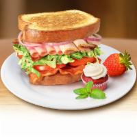 Sassy Club Sandwich · Tender turkey breast, honey ham, hardwood smoked bacon, provolone cheese, tomato, romaine le...