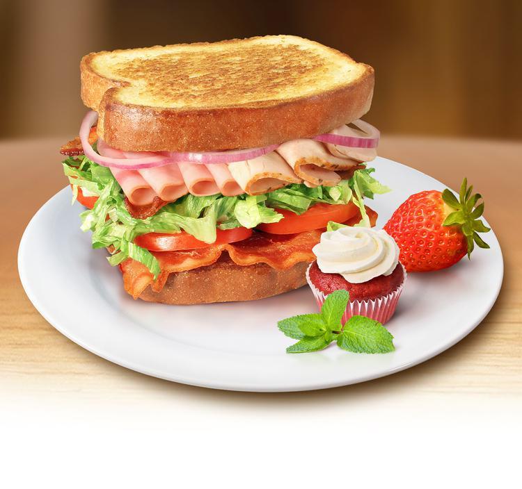Sassy Club Sandwich · Tender turkey breast, honey ham, hardwood smoked bacon, provolone cheese, tomato, romaine lettuce, with honey mayo sauce served on toasted white bread.