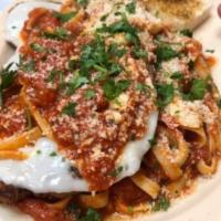 Chicken Parmesan · Breaded chicken breast served with fettuccine noodles topped with marinara sauce, provolone ...