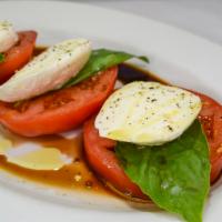 Caprese Salad · Beefsteak tomatoes, fresh mozzarella, basil and extra virgin olive oil.
