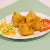 2 Piece Meat Samosa · Triangular pies stuffed with ground meat, onion, peas, herbs and spices.