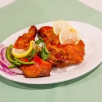 Tandoori Chicken · Half chicken marinated in fresh spices with yogurt and roasted in the Indian traditional cla...