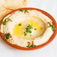 Hummus · Mashed chickpeas, olive oil, lemon juice, garlic, tahini and special spices. Served with pit...