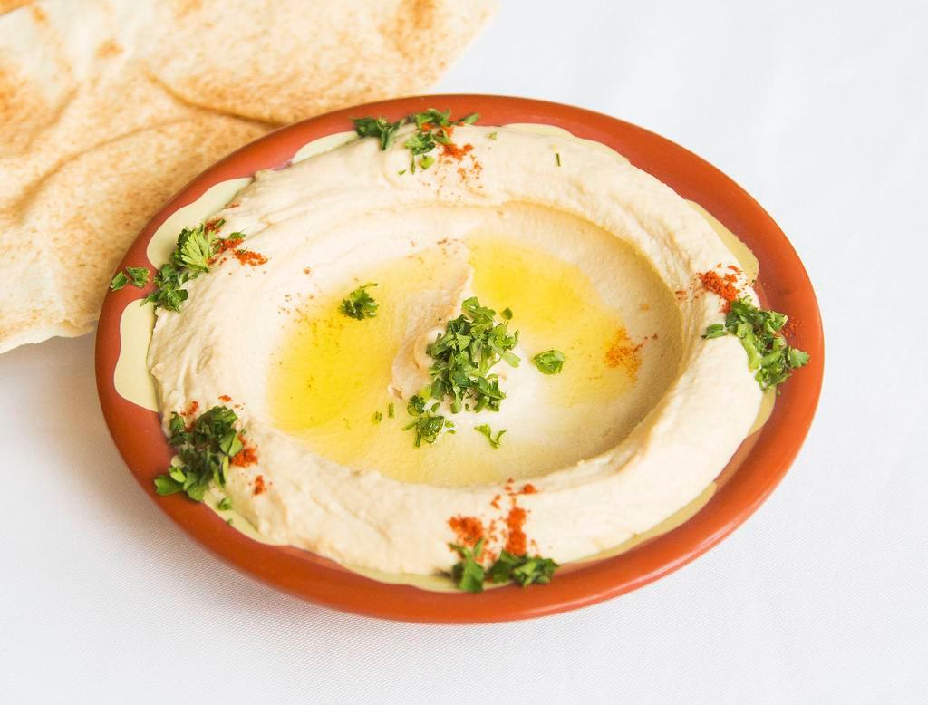 Hummus · Mashed chickpeas, olive oil, lemon juice, garlic, tahini and special spices. Served with pita bread