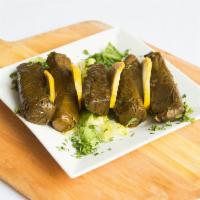 6 Piece Grape Leaves · Hand rolled grape leaves stuffed with rice, tomatoes, onions in lemon juice and olive oil.