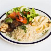 Beef Kebob · Beef marinated in our special spices. Served with hummus, salad, grilled vegetables and rice.