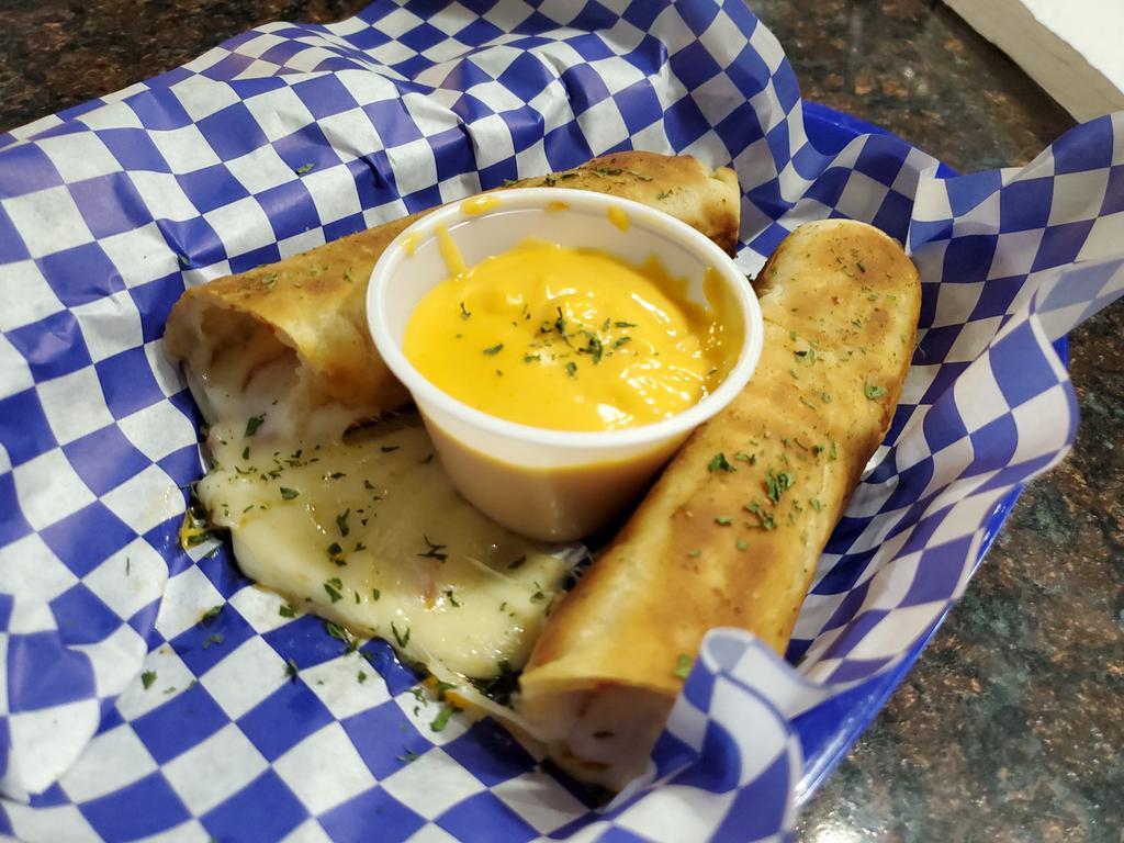 Stuffed Breadsticks · 4 bread-sticks stuffed with pepperoni and mozzarella cheese. Served with marinara or nacho cheese.