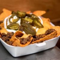 Nachos · Your choice of chips, meat with jalapeno peppers and sour cream.
