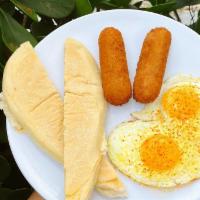 Dos Croquetas + Eggs + Tostada · Dos Croquetas paired with scrambled or sunny side up eggs and buttery cuban toast.br /