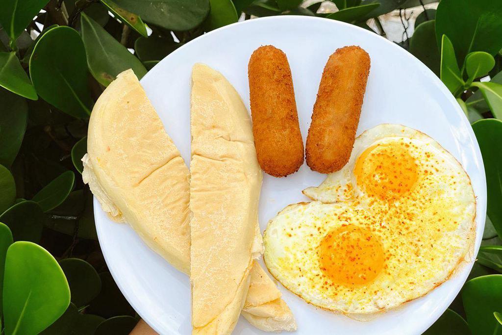 Dos Croquetas + Eggs + Tostada · Dos Croquetas paired with scrambled or sunny side up eggs and buttery cuban toast.br /