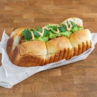 Mexican Style Hot Dog · Polish sausage, guacamole, pico de gallo, sriracha mayonnaise, jalapeno, and cilantro.