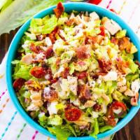Cobb Salad · Grilled chicken, sliced egg, tomatoes, onions, cucumbers, bacon, bleu cheese crumbles over c...